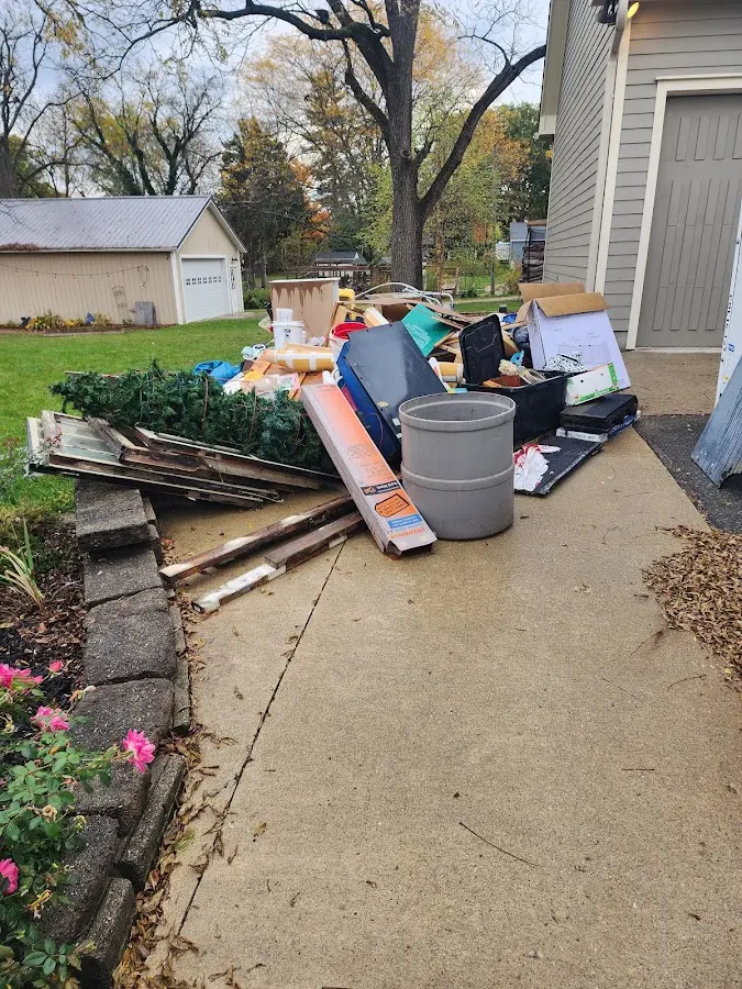 Dumpster being loaded with debris for Estate Cleanout Dumpster Rental in Bath